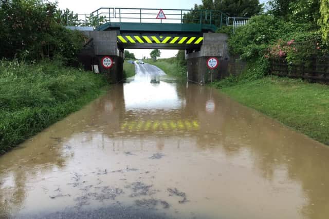 The flood waters beneath the railway bridge over Station Road, Potterhanworth this afternoon. Photo: Lincs Police Specials. EMN-160615-212828001