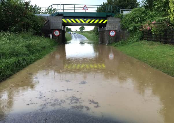 The flood waters beneath the railway bridge over Station Road, Potterhanworth this afternoon. Photo: Lincs Police Specials. EMN-160615-212828001