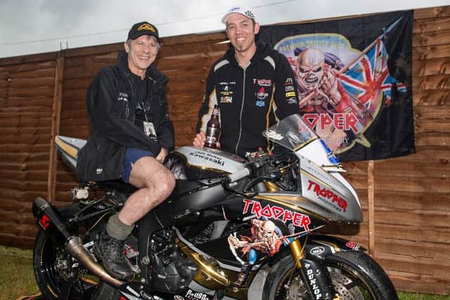 Iron Maiden lead singer Bruce Dickinson tries Peter Hickman's bike out for size EMN-160620-155616002