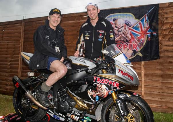Iron Maiden lead singer Bruce Dickinson tries Peter Hickman's bike out for size EMN-160620-155616002
