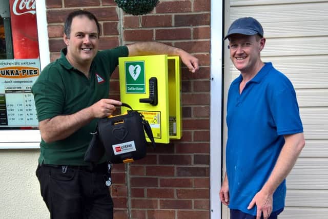Mike Keal, coordinator of Metheringham LIVES Community Responders and Martin Holroyd, proprietor of Great Barrier Reef fish and chip shop. EMN-160627-092543001