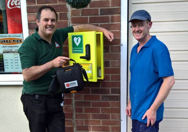 Mike Keal, coordinator of Metheringham LIVES Community Responders and Martin Holroyd, proprietor of  Great Barrier Reef fish and chip shop. EMN-160627-092543001