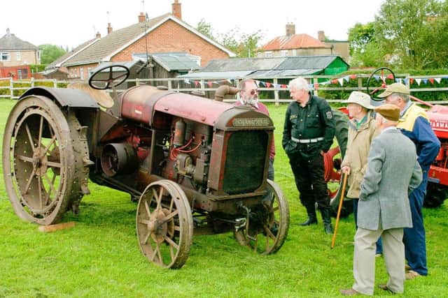 Visitors to the show were interested in some of the vintage tractor exhibits. EMN-160623-164041001