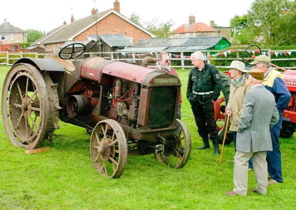 Visitors to the show were interested in some of the vintage tractor exhibits. EMN-160623-164041001