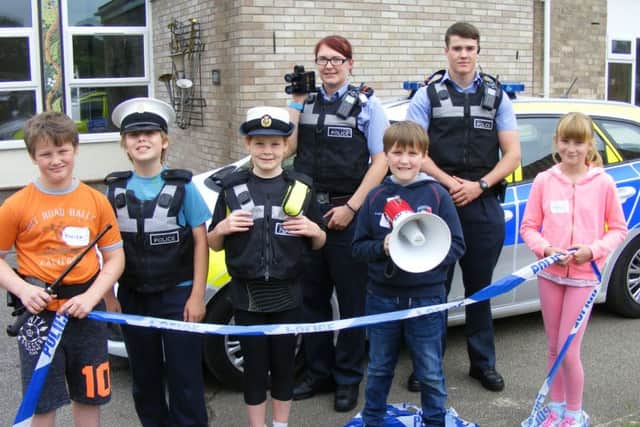 Youngsters with RAF Police Cpl Rachel Free and Cpl Billy Smith. EMN-160623-105608001