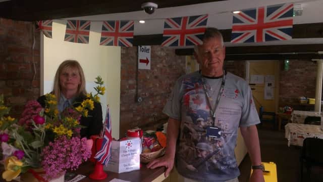 Kellie North, assistant manager at the Village Church Farm museum, with volunteer Rodney Martin saluting Armed Forces Day with a special wartime exhibition. ANL-160625-182206001