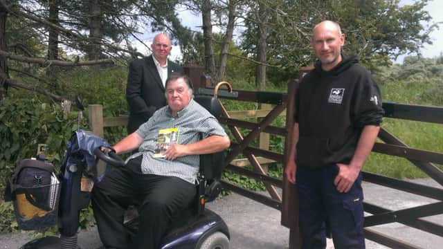 Disabled Paul Marshall (centre) with Coun Colin Davie and Kev Wilson, warden at Gibraltar Point Nature Reserve., ANL-160626-103840001