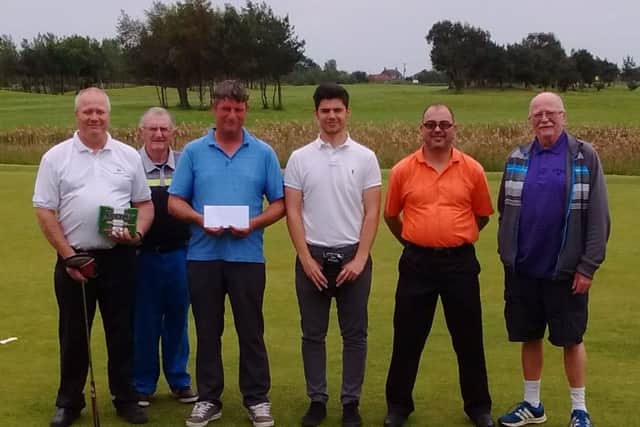 The winners line-up after the golf fundraiser.