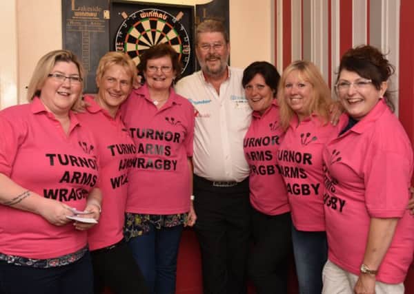 The Turnor Arms ladies' darts team with Wolfie Picture: John Edwards EMN-160627-125554002