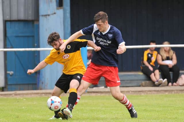 Jamie McGhee and Simon Ashton tussle during last season's encounter.