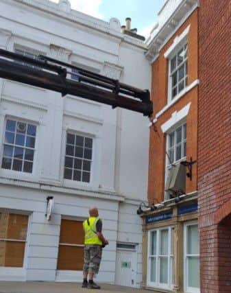 The safe prepares to take flight from the first storey window at Wilkin Chapman LLP Solicitors in Louth's Cornmarket.