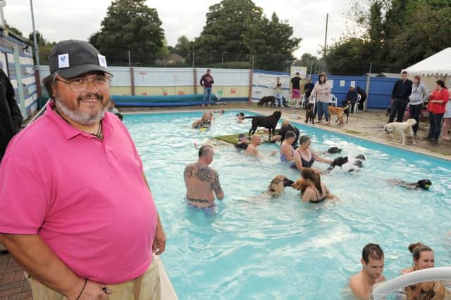 A lifesaver. Michael Wells at last season#s doggie swims which narrowly ept the pools finances afloat. EMN-160407-154012001