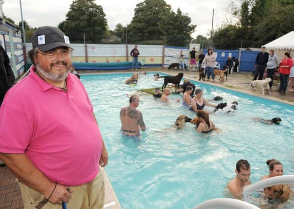 A lifesaver. Michael Wells at last season#s doggie swims which narrowly ept the pools finances afloat. EMN-160407-154012001