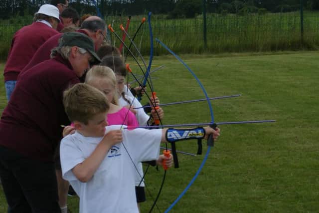 Brant Broughton School try their hand at archery. EMN-160607-150033001