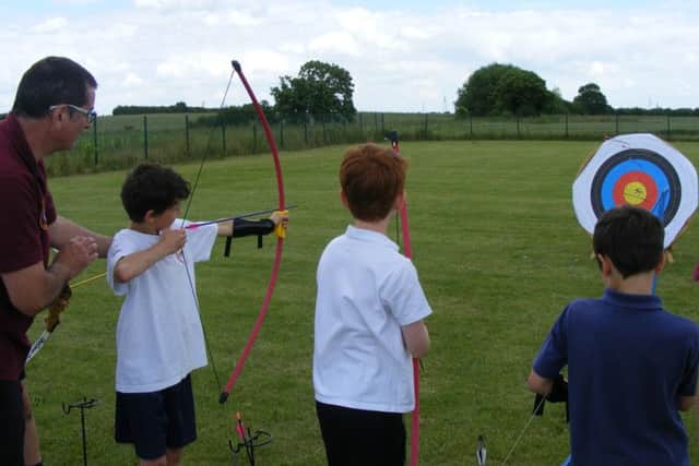 Brant Broughton School try their hand at archery. EMN-160607-150046001