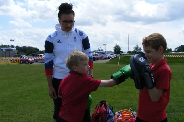 Olympic swimmer Sophie Allen, from Fulbeck, coaches boxercise to Church Lane School pupils Connor McHugh and Thomas Leak. EMN-160607-145951001