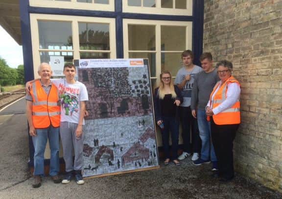 Students present their artwork to Station Adoption Group secretary Martin Barnard, left EMN-161207-164605001