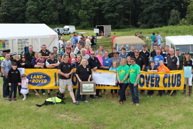 Lincolnshire Land Rover Club presented ?2,160 to the Lincolnshire and Nottinghamshire Air Ambulance at Brocklesby Show. EMN-161207-154131001