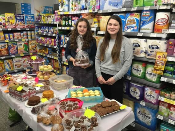 Nepal bound: Ashleigh Burton-Melling and Hermione Daulat at their fundraising cake sale