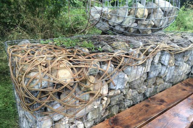 The rock and wire bench which had been repaired and later damaged again. EMN-161207-141055001