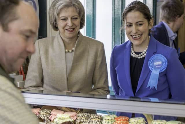 Theresa May and Victoria Atkins at RJ Hirst last year.