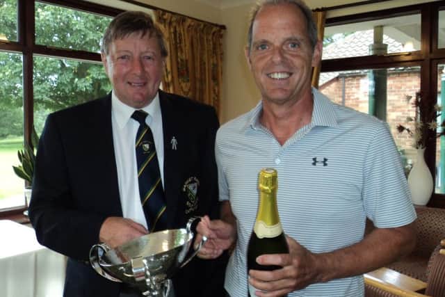Men's captain Les Brumpton (left) presents the Harmsworth Trophy To Neil Carmichael EMN-160718-104552002