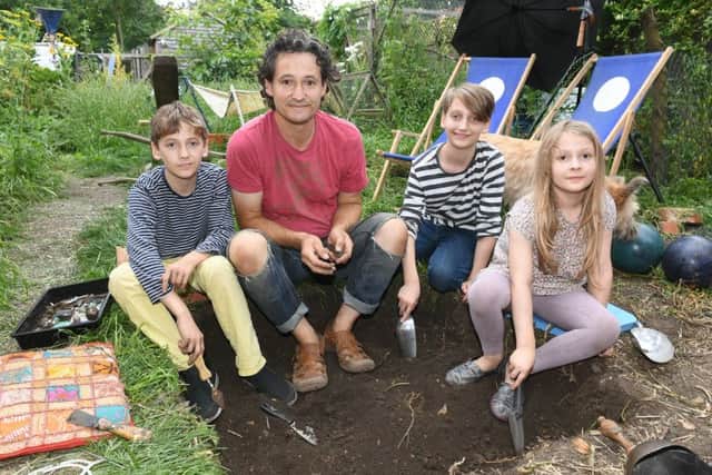Heckington Community Archaeology weekend with Heritage Lincs. L-R Oskar Steadman 10, Mark Steadman, Harry Steadman 12, Emily Steadman 8, digging in their garden on Church Street. EMN-160725-173016001