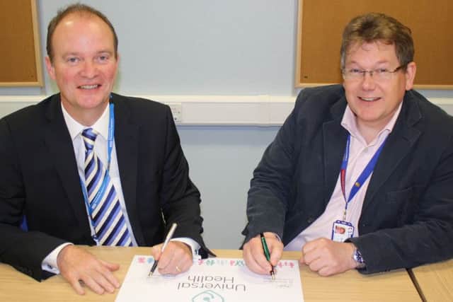 Back in April 2015 when Dr John Brewin (left), Chief Executive of Lincolnshire Partnership NHS Foundation Trust and Dr Neal Parkes (right), Chief Executive of Lincolnshire and District Medical Services signed the Universal Health partnership to take charge of the Metheringham GP surgery. EMN-160722-102850001