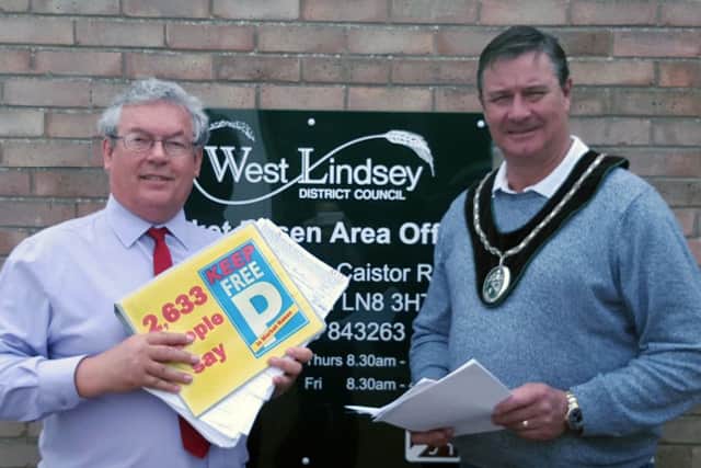 Local businessman Adrian Campbell and Town Mayor John Matthews with the petition they presented to WLDC, containing 2,633 names opposing car park charges in Market Rasen EMN-160725-153158001