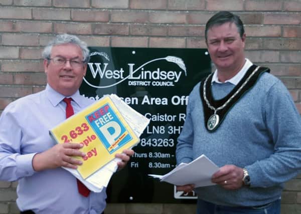 Local businessman Adrian Campbell and Town Mayor John Matthews with the petition they presented to WLDC, containing  2,633 names opposing car park charges in Market Rasen EMN-160725-153158001