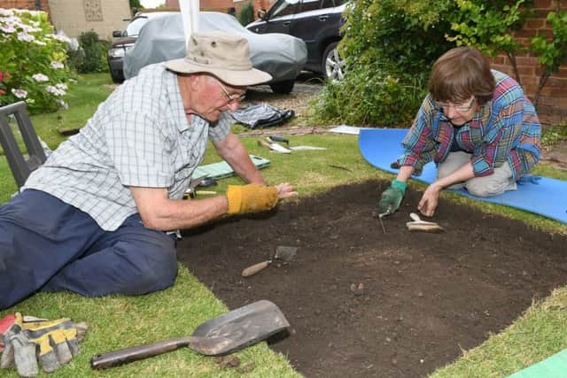 Heckington Community Archaeology weekend with Heritage Lincs. Margaret and Peter Green digging in Margaret's sister's garden, on Church Street. EMN-160725-172949001