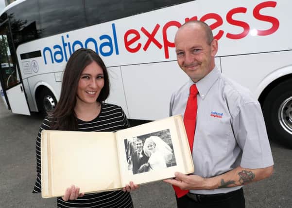 Rosalyn Golds, Head of Media National Express and Shaun Stead, coach driver with the August 7, 1965 wedding photo album of Brian Lewis and Patricia Cavanagh at St Clement's Church, which they would like to reunite with the family. Photo: Adam Fradgley EMN-160727-172821001