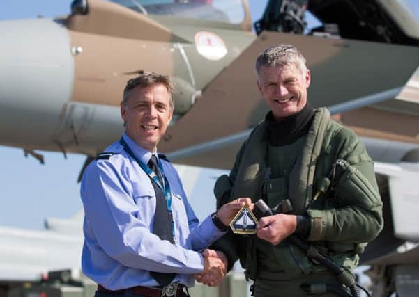 Air Commodore Duguid (left) presents Flt Lt Watts with his patch EMN-160729-090342001