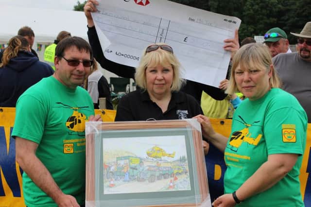 Lincs Land Rover Club recently presented a big cheque to the Lincs and Notts Air Ambulance.