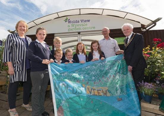 L-R former Mayor Angela Birchall (who helped judge the competition), winner Chloe Dobbs, Jacob (3rd prize winner also from Kirkby on Bain Primary School), Aaron, Megan (Chloes sister) Casey, Rebecca, Wolds View garden centre manager Ken Dawson, Horncastle Mayor and County Councillor Bill Aron. EMN-160308-130549001
