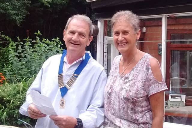 Outgoing President Jackie Jewell with new Club President Lion Neil Marshall EMN-160308-132444001