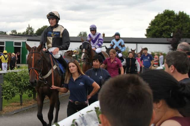 Placed horses in the Susan Skinner Handicap Hurdle return to the winners enclosure, with winner Ruariadh Hugh at the back, ridden by Tommy OBrien EMN-160108-092805002