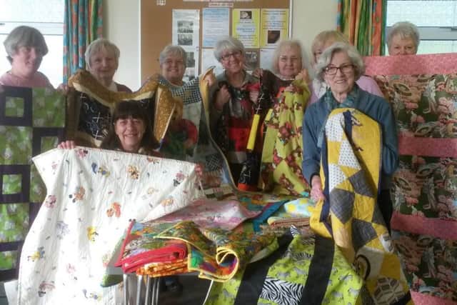 Pictures from a previous sewing day holding quilts and blankets made