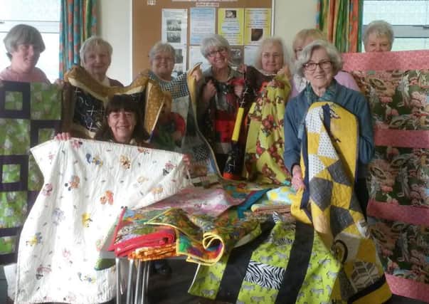 Pictures from a previous sewing day holding quilts and blankets made