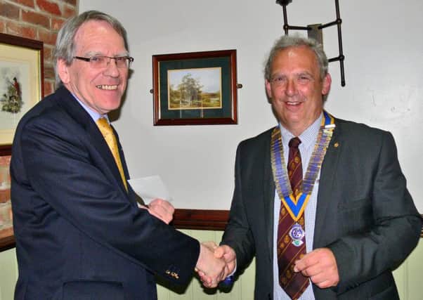 Retiring Brigg Rotary President Nick Wells (right) hands over a cheque for ?500 to Richard Alderson from Nettleton of Lincolnshire Rural Stress Network, some of the total sum of ?4,000 awarded to local charities. EMN-161008-220500001