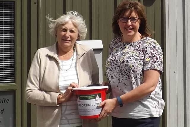 Pat Rowett, left, presented ?1,215 raised at her open garden to LIVES CEO Nikki Silver EMN-161008-120604001
