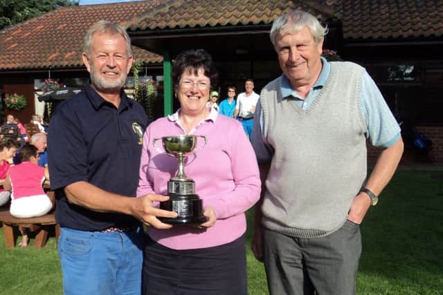 Market Rasen GC president Richard Holmes (left) presents the Oldroyd Cup to Jane Salt and John Boulton EMN-160508-115043002