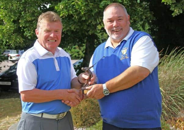 Eric Turner (left) receives the Les Atkinson seniors Trophy from seniors captain Terry Winter EMN-160815-145256002