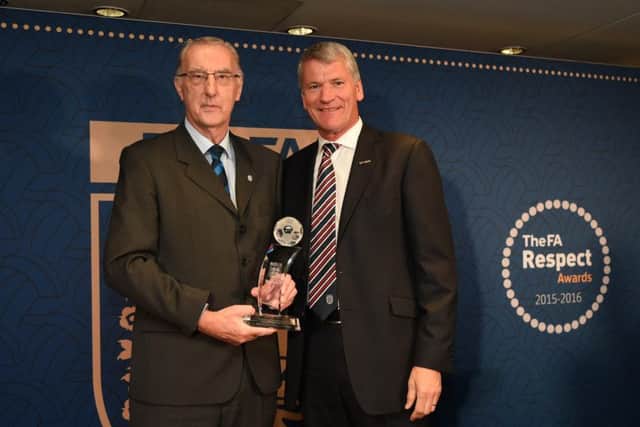 Pictured is Roger Gell receiving the award from David Gill.