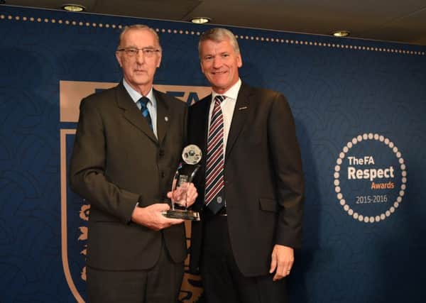 Pictured is Roger Gell receiving the award from David Gill.