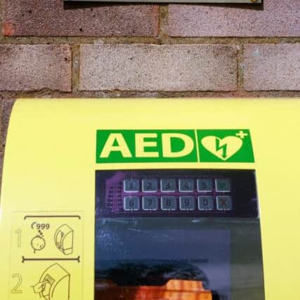 A defibrillator and plaque have been placed on the wall of Brigg Youth Centre in memory of teacher Adrian Gibbons. EMN-160818-120700001