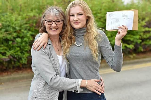 Abigail Hunter and mum Helen Hunter - a teacher at QEGS - celebrate a 100 per cent success rate. EMN-160818-082348001