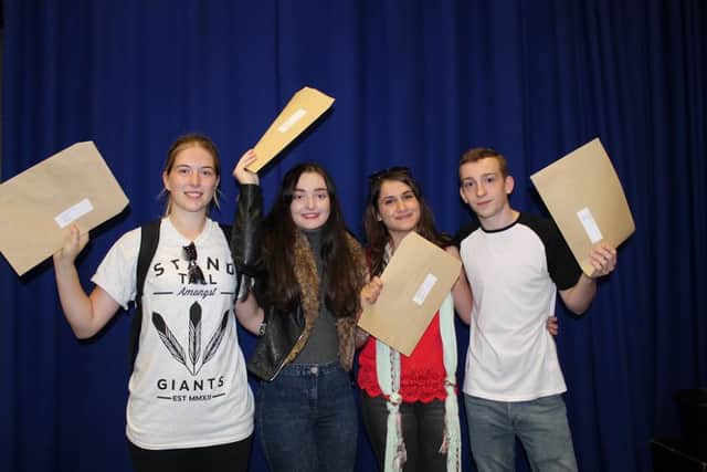 Cerys Meredith, Gemma Mendham, Florence Seigneury and Henry Verity celebrate their A-Level results at Monks' Dyke Tennyson College.