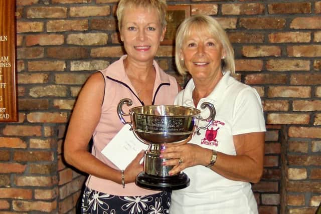 Lynn Worthington receives the Bothamley Bowl Trophy from Lady Captain Anne Wallhead.