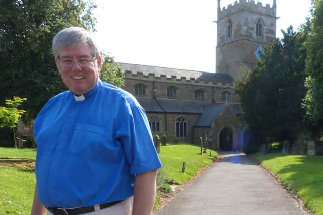 The Rev Canon Ian Robinson outside Caistor Parish Church EMN-160829-163326001